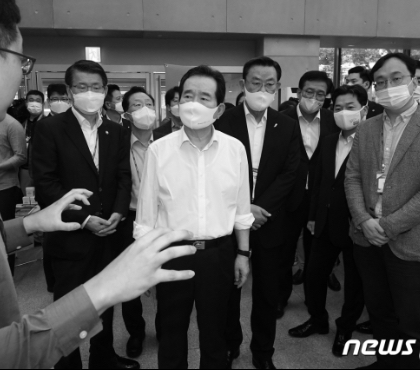 Prime Minister Sye-gyun Jeong looks at the...